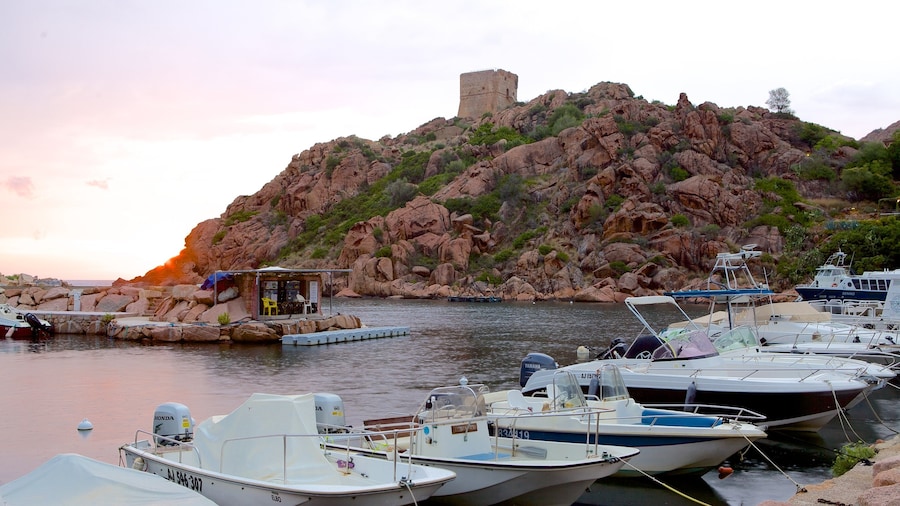 Genoese Tower featuring rocky coastline, a sunset and a bay or harbour