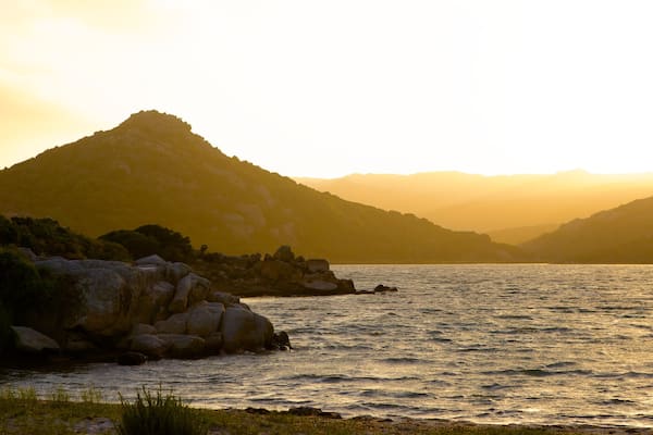 Plage de Balistra montrant côte rocheuse et coucher de soleil