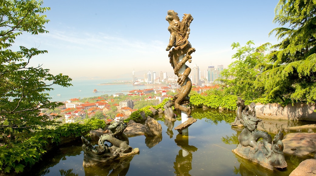 Qingdao showing a coastal town and a pond