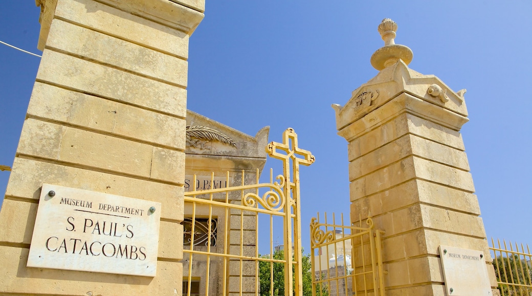 Catacombs of St. Paul and St. Agatha\'s Crypt showing a cemetery, signage and religious aspects