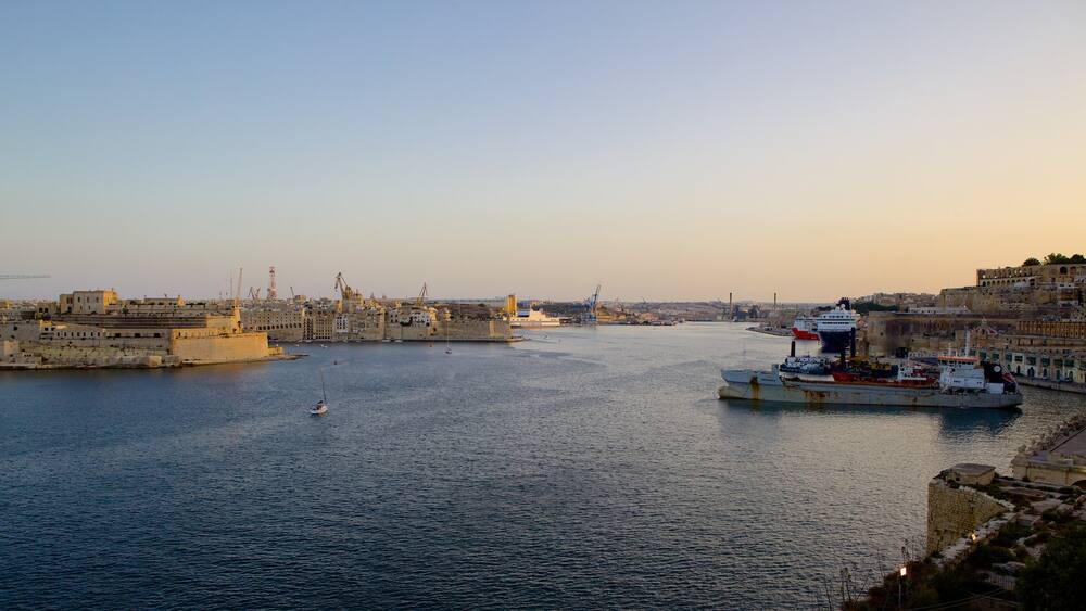 Grand Harbour featuring a bay or harbour, a sunset and a coastal town