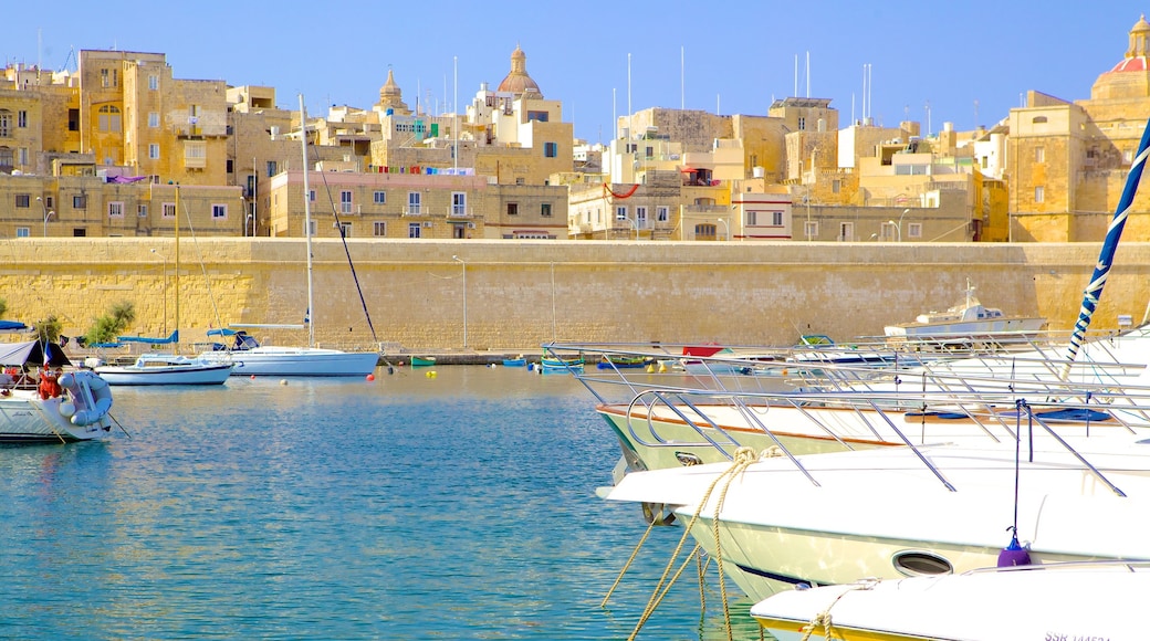 Kalkara which includes heritage architecture, a coastal town and a bay or harbour