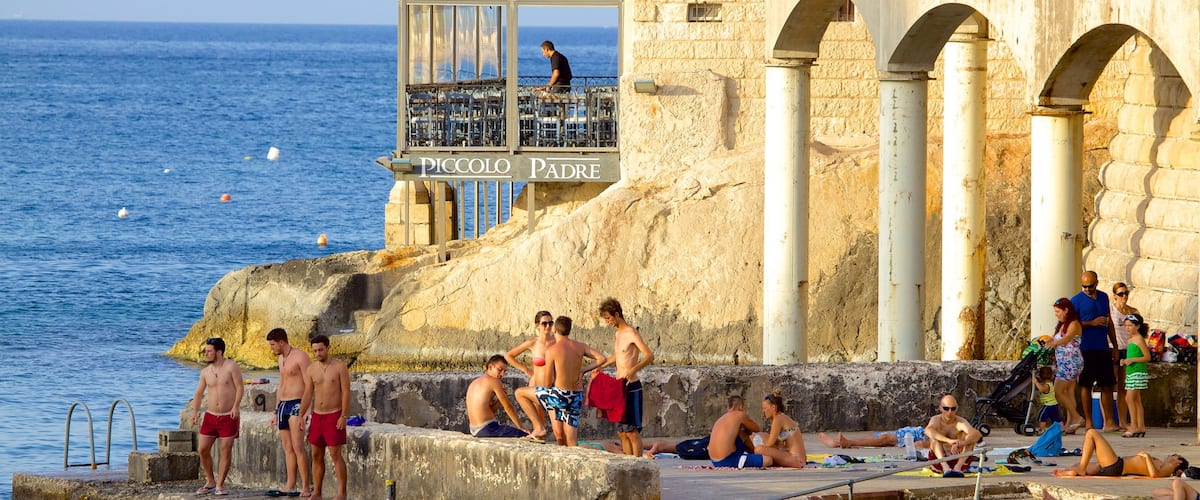 Balluta Bay which includes heritage architecture as well as a large group of people