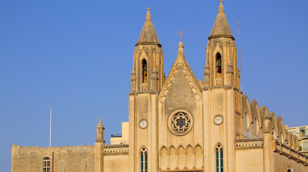 Balluta Bay which includes heritage architecture and a church or cathedral