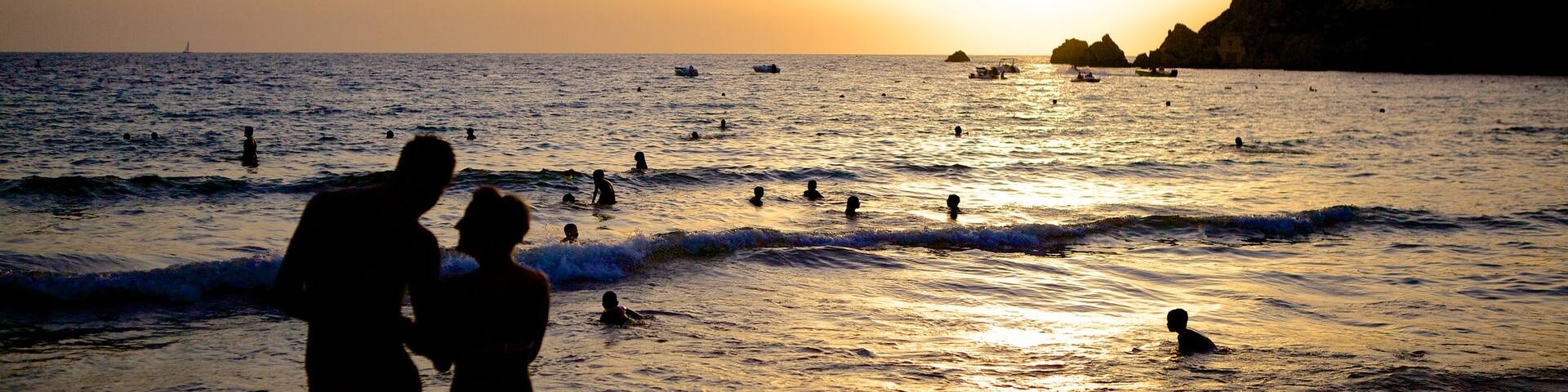 Golden Sands Beach featuring a sunset as well as a couple