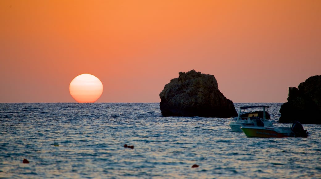 Golden Sands Beach showing rugged coastline and a sunset