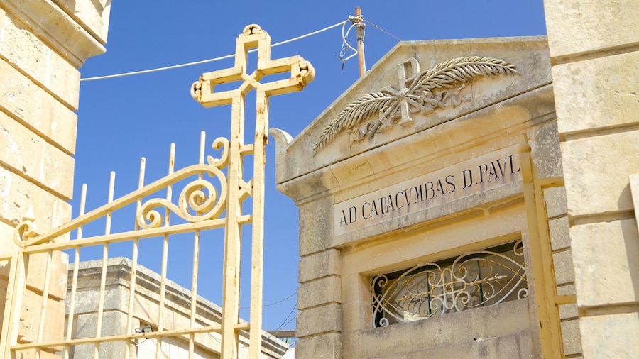 Catacombs of St. Paul and St. Agatha\'s Crypt featuring signage, religious elements and a cemetery