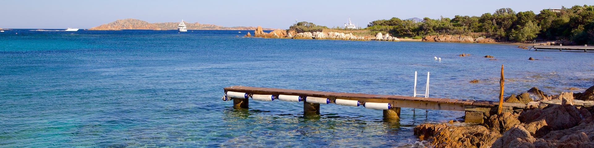 Romazzino Beach featuring rugged coastline and general coastal views