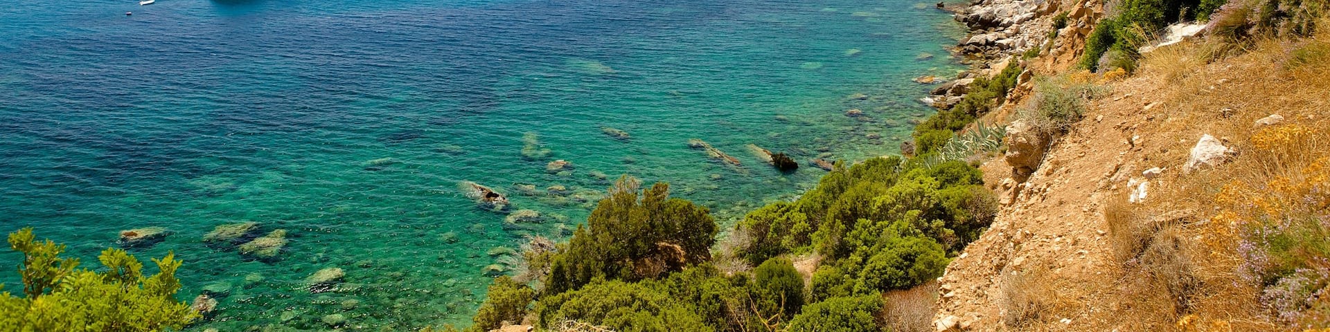 Porto Flavia featuring rugged coastline