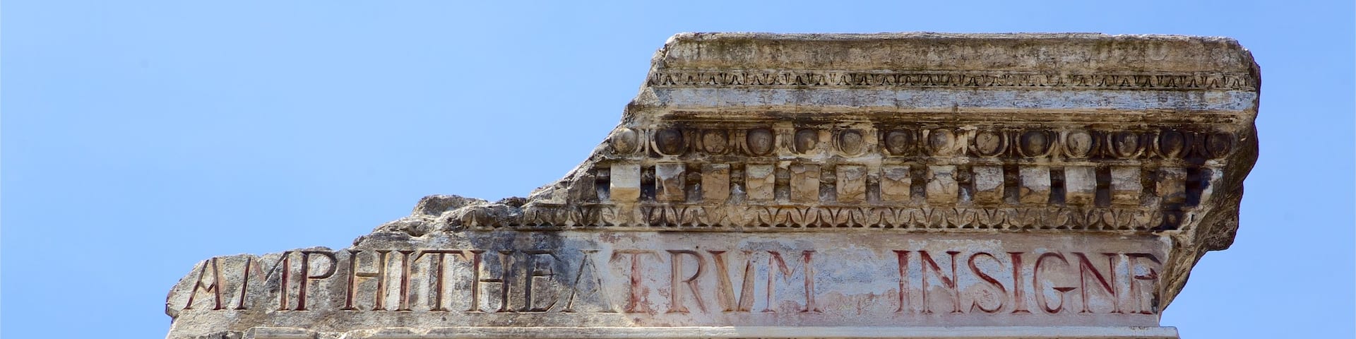 Roman Amphitheater featuring building ruins and signage