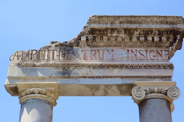 Roman Amphitheater showing signage and a ruin