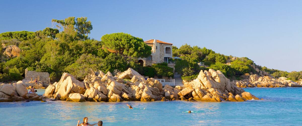 Capriccioli Beach which includes a coastal town, swimming and landscape views