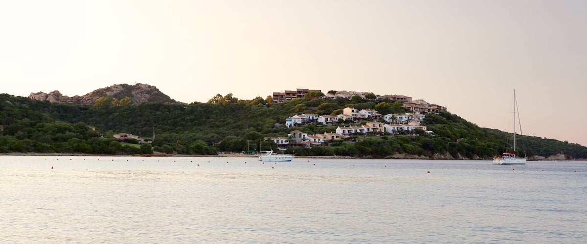 La Marinella Beach which includes boating, a coastal town and general coastal views