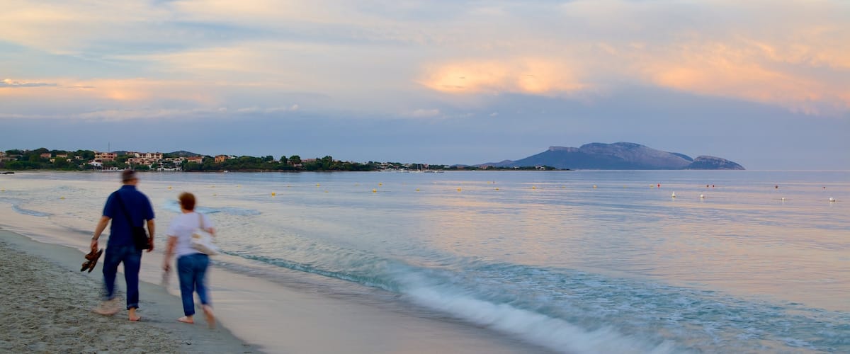 Pittulongu Beach which includes a sunset and a beach as well as a couple