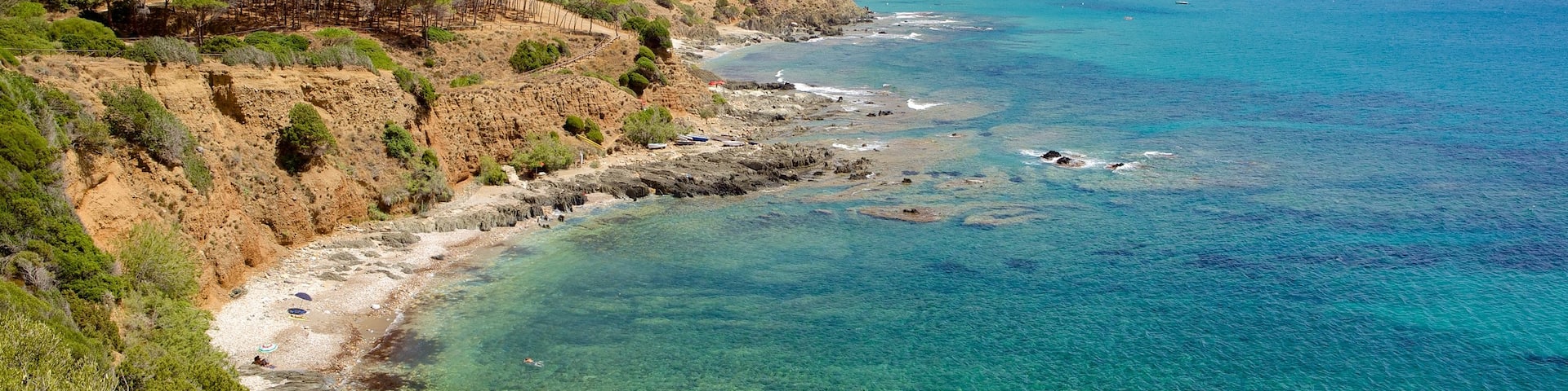 Porto Flavia featuring rugged coastline