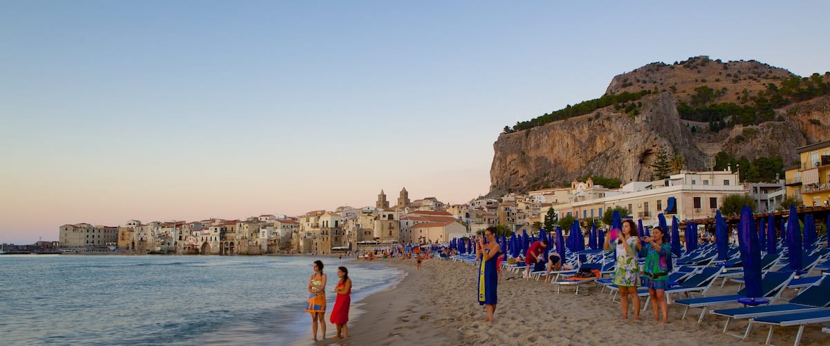 Rocca of Cefalu which includes a beach and a coastal town