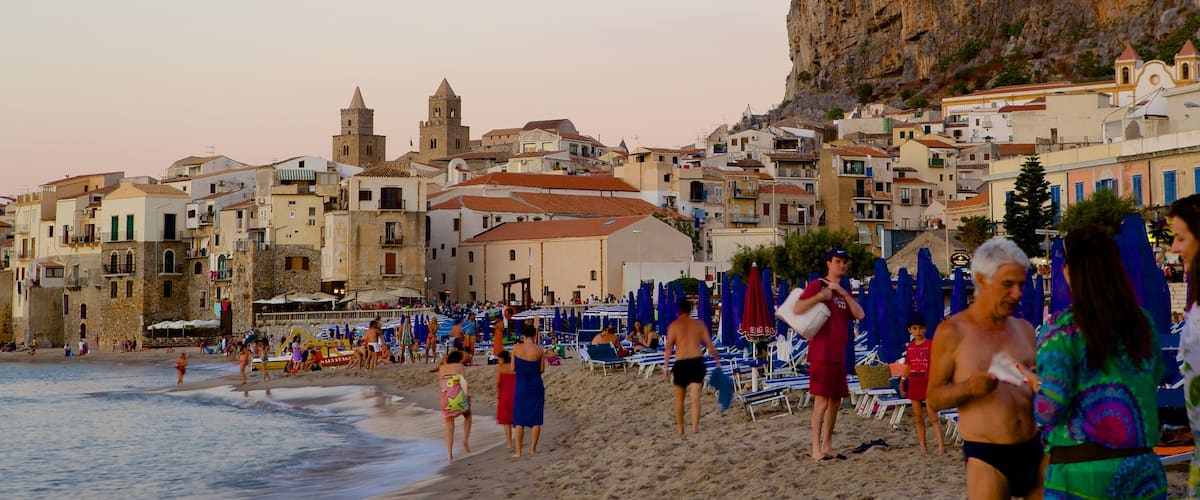 Rocca of Cefalu which includes a coastal town, a sandy beach and heritage architecture