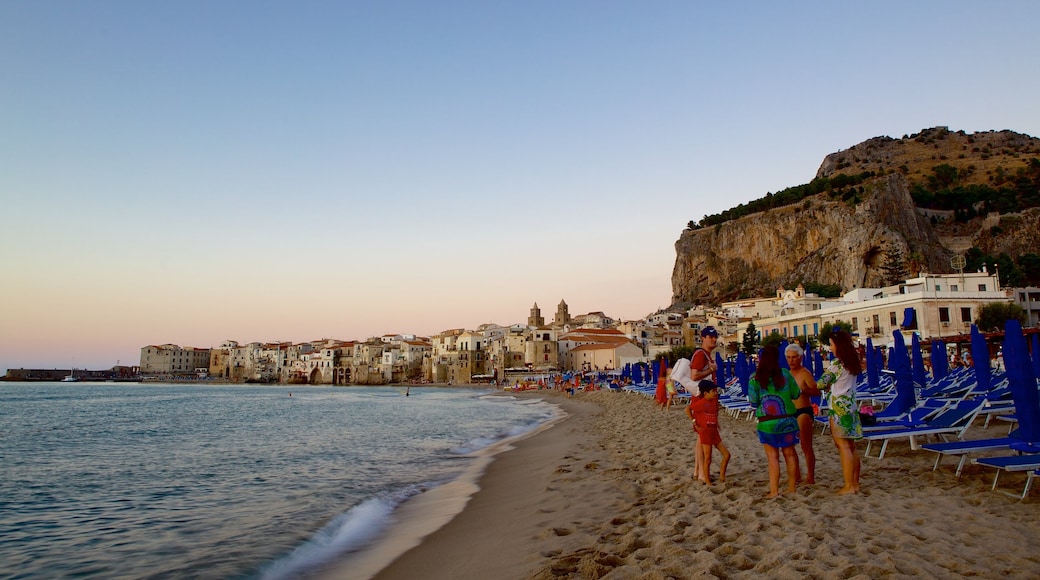 Cefalu Coast which includes general coastal views, a sunset and a beach