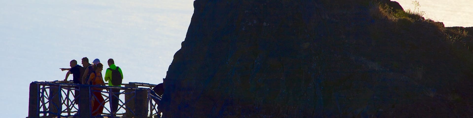 Pico do Ariero showing mountains and views as well as a small group of people