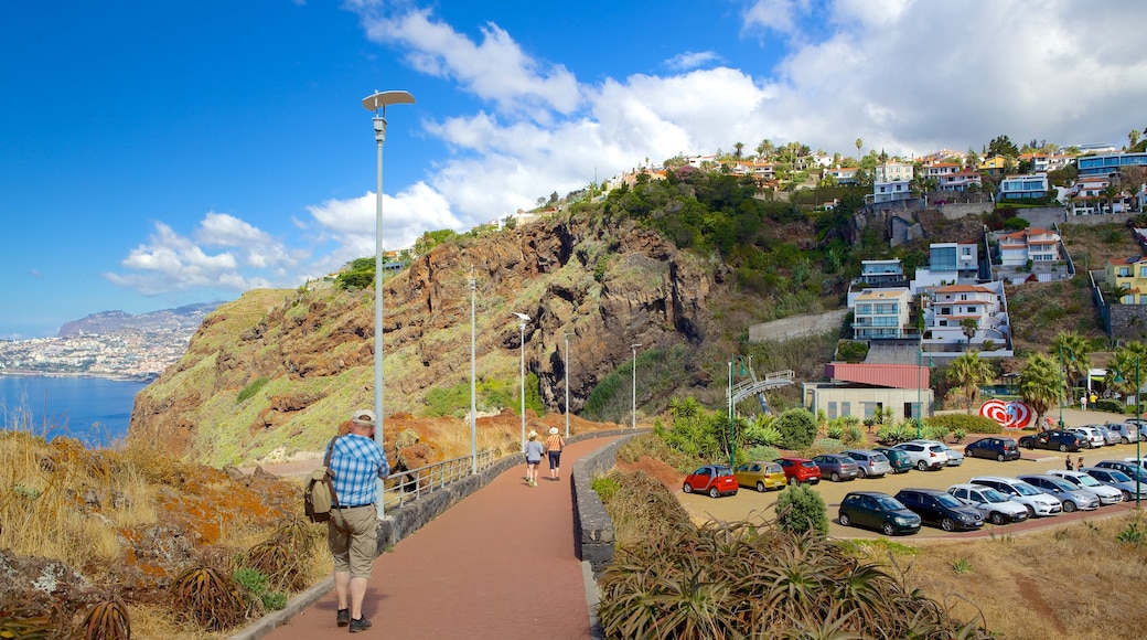 Ponta da Oliveira showing a coastal town as well as an individual male