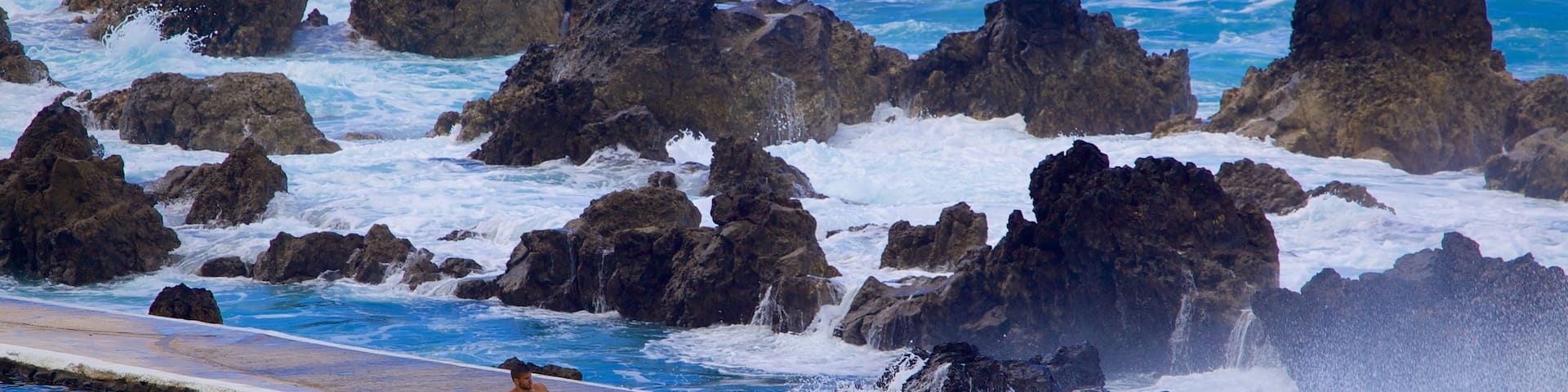 Porto Moniz Natural Pools featuring a pool and rugged coastline
