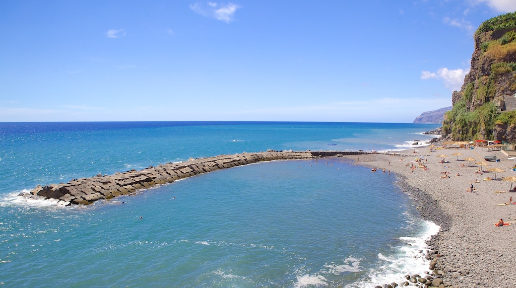 Ponta Do Sol Beach showing rugged coastline and a pebble beach