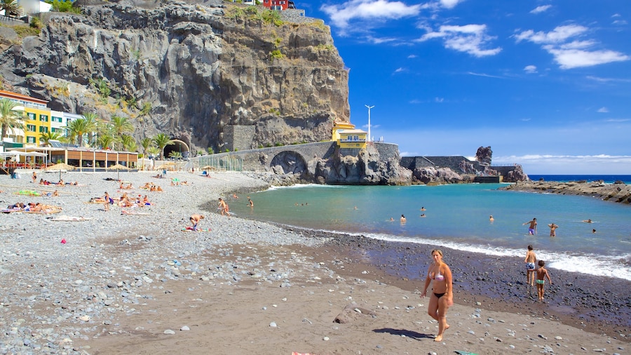 Ponta Do Sol Beach featuring swimming, a coastal town and a pebble beach