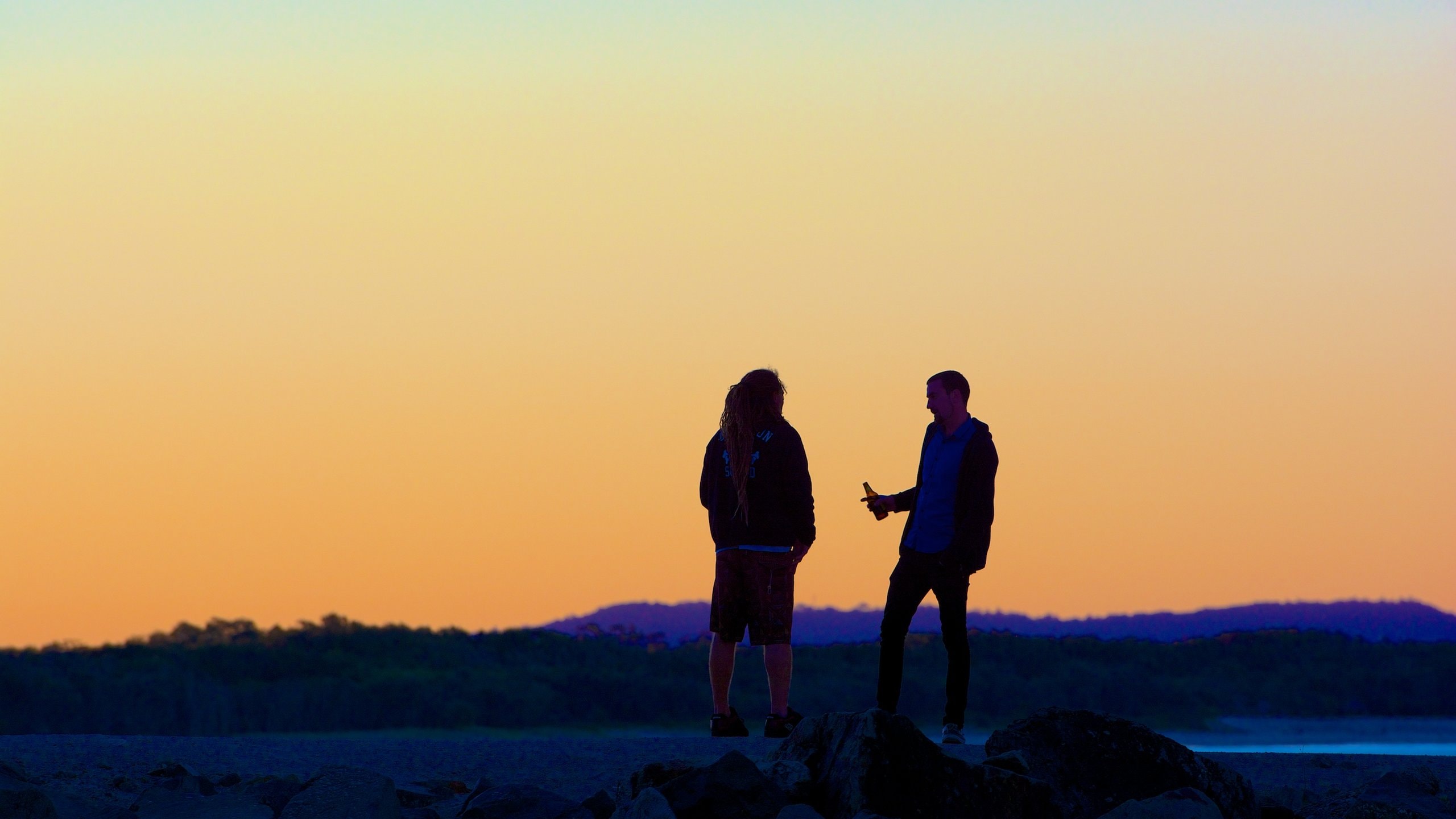 Noosa Beach showing a sunset as well as a couple