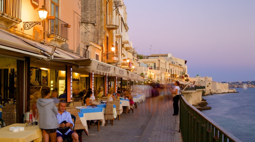 Ortygia showing general coastal views, outdoor eating and a sunset