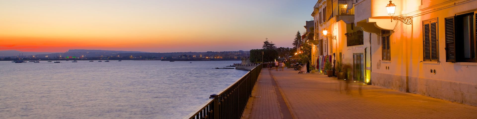Ortygia featuring a sunset, a coastal town and street scenes