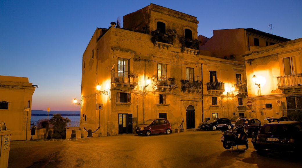 Ortygia which includes a coastal town, a sunset and street scenes