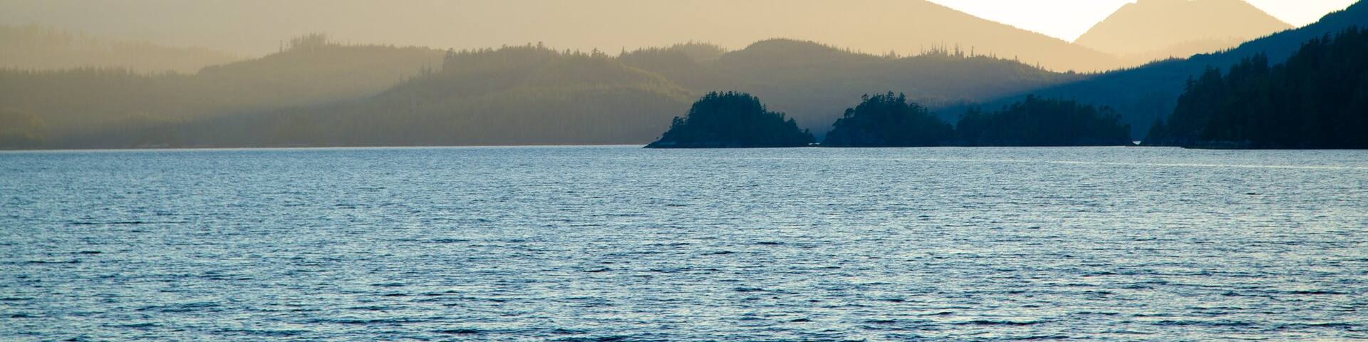 Clayquot Arm Provincial Park showing mountains, mist or fog and a sunset
