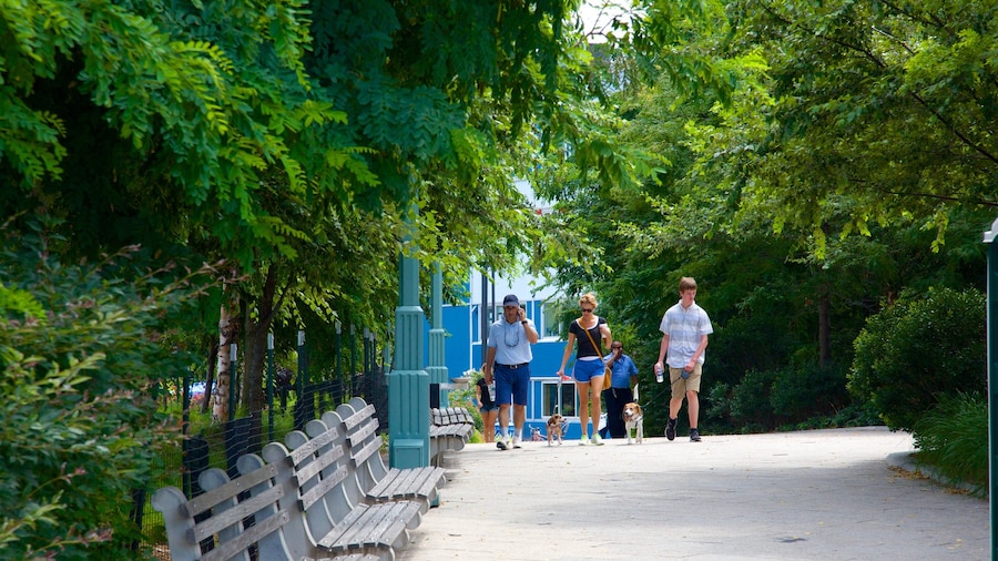Hudson River Park featuring a garden as well as a small group of people