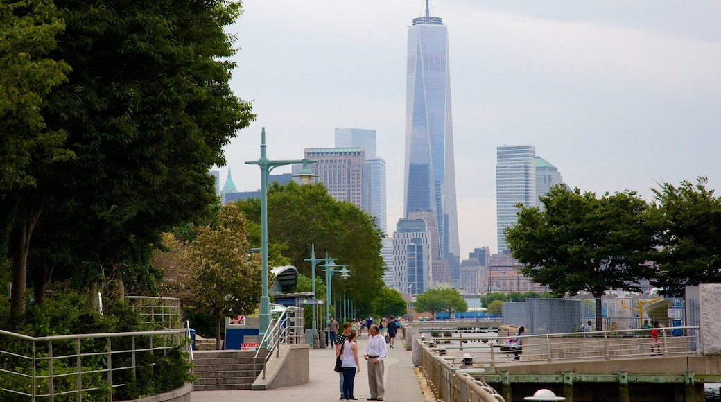 Hudson River Park showing a city as well as a small group of people