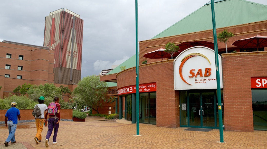 Museum Africa featuring a city and signage as well as a small group of people