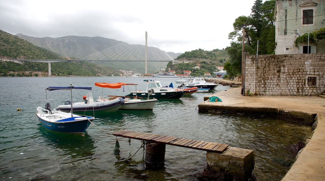 Lapad Beach showing a lake or waterhole, a bridge and boating