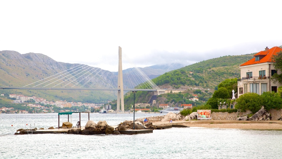 Copacabana Beach which includes a sandy beach, a bay or harbour and a bridge