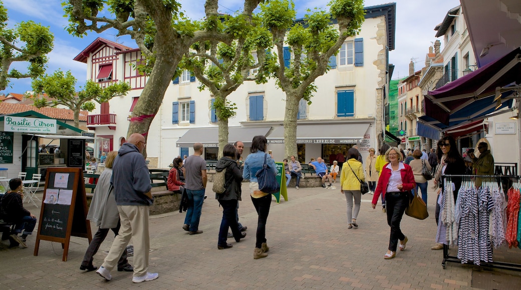 Saint-Jean-de-Luz which includes markets and a square or plaza as well as a large group of people