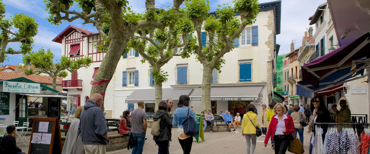 Saint-Jean-de-Luz featuring markets and a square or plaza as well as a large group of people