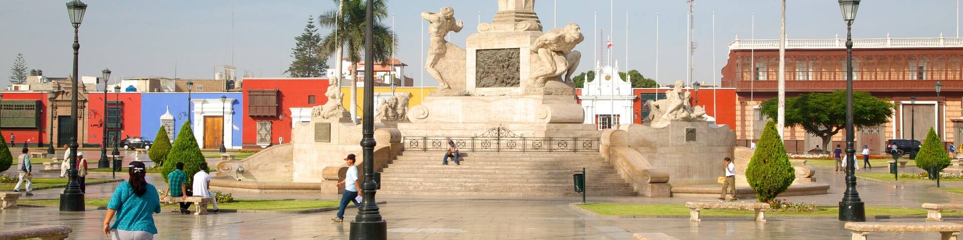 Trujillo Plaza de Armas featuring a statue or sculpture and a square or plaza as well as a small group of people