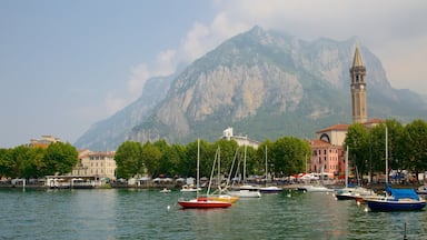 Lecco que incluye montañas, botes y una ciudad costera