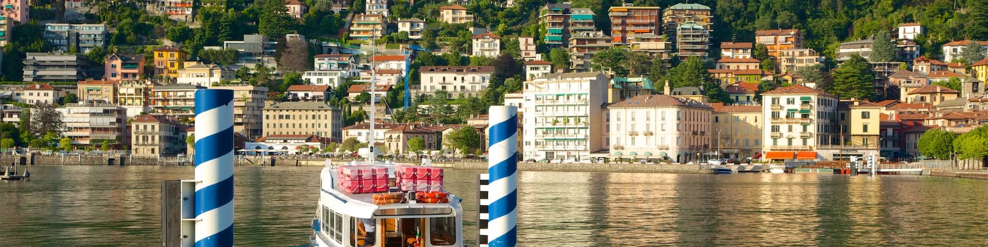 Piazza Cavour featuring a marina, a ferry and a coastal town