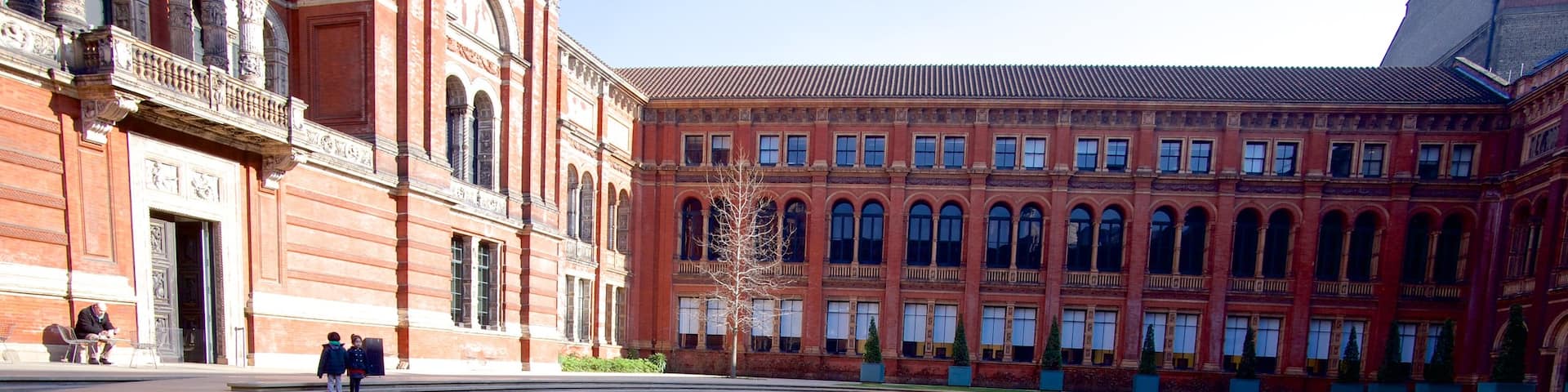 Victoria and Albert Museum showing a square or plaza and a fountain