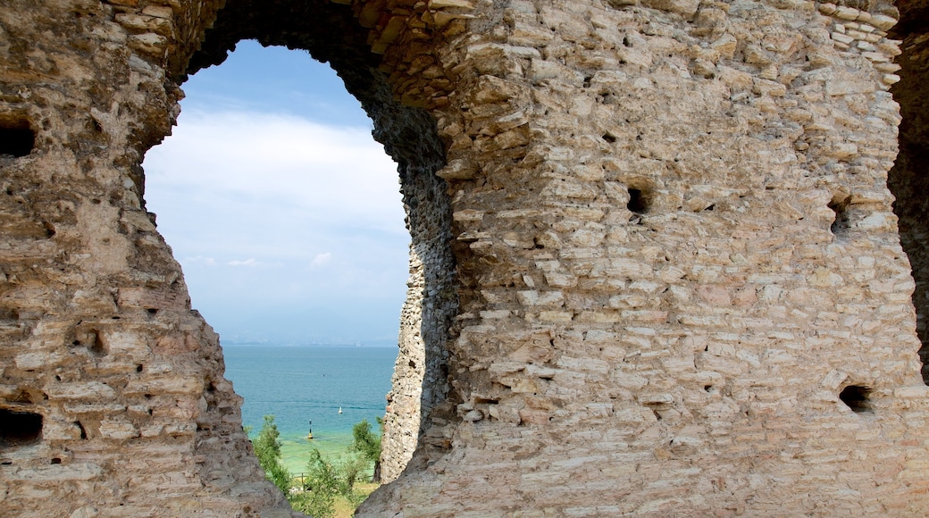 Grotte di Catullo che include oggetti d\'epoca, lago o sorgente d\'acqua e rovine