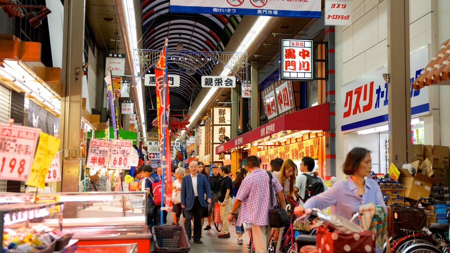 Kuromon Ichiba Market with food stalls and shoppers in Osaka, Japan.