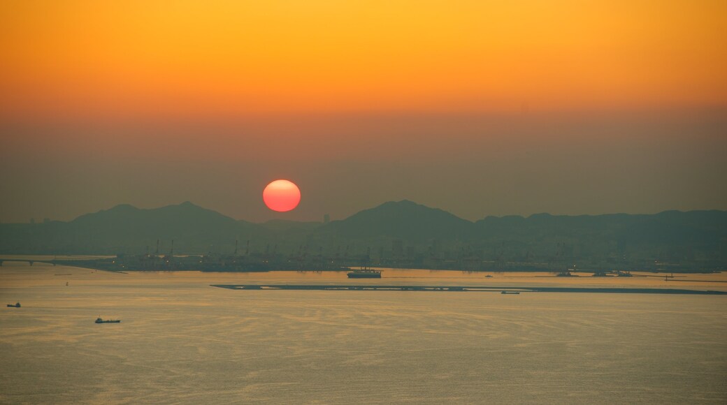 Osaka Prefectural Government Sakishima Building showing a sunset and a bay or harbour