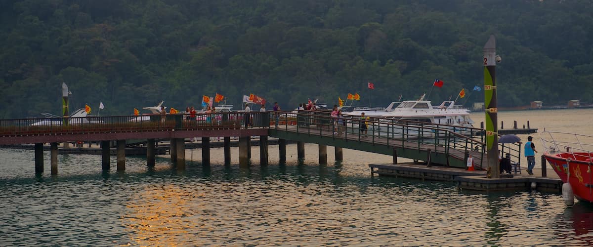 Sun Moon Lake which includes a lake or waterhole, a sunset and a bay or harbour