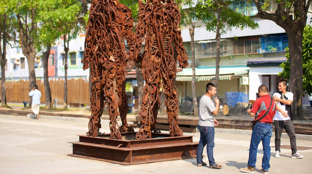 Pier-2 Art Center showing outdoor art and a statue or sculpture as well as a small group of people