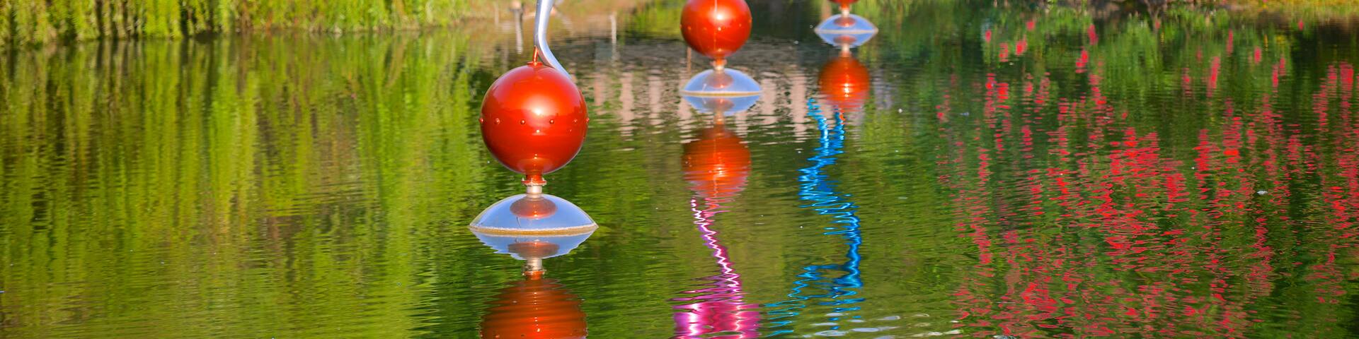 Central Park featuring a lake or waterhole, outdoor art and a park