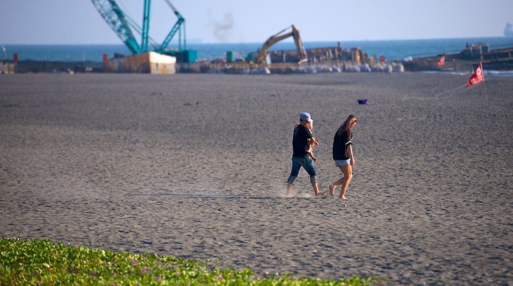 Cijin Seaside Park featuring a sandy beach as well as a small group of people